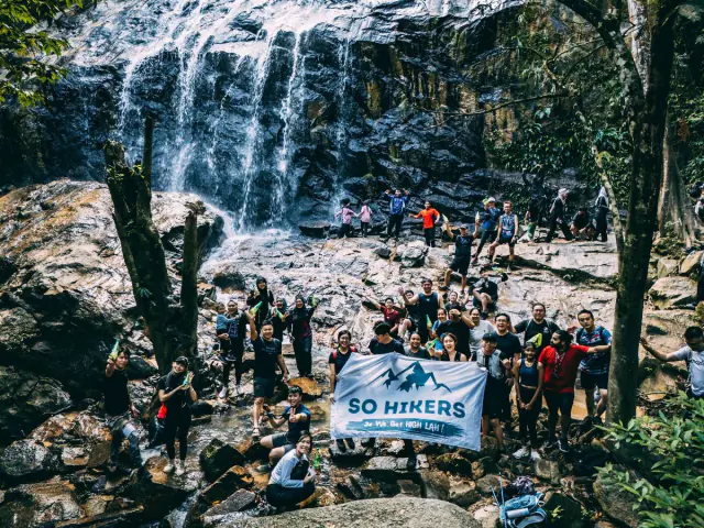 Waterfall group photo with SO HIKERS flag