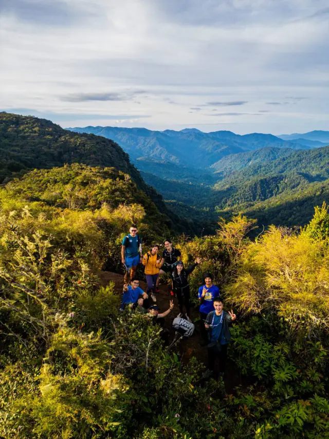 Small group on mountain ridge at golden hour