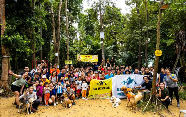 Group at jungle temple trailhead with So Hikers flag