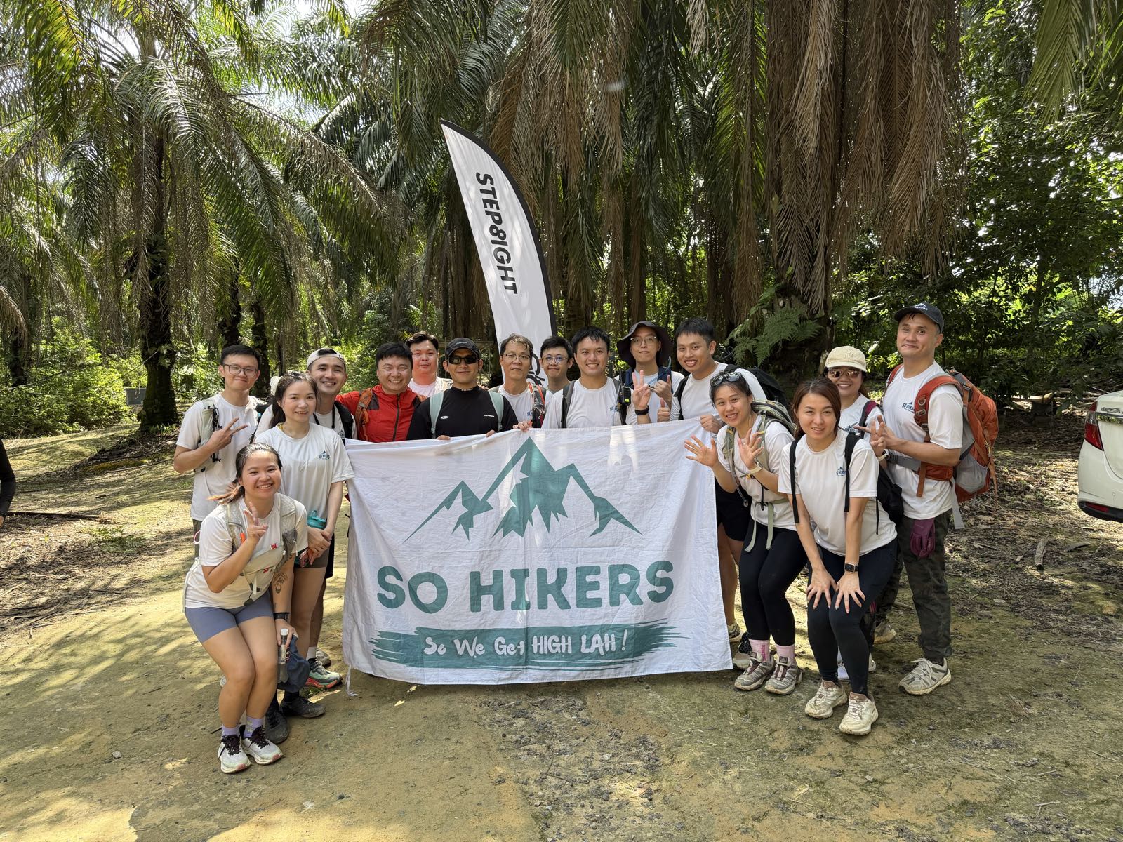 So Hikers group photo with flag at the trailhead