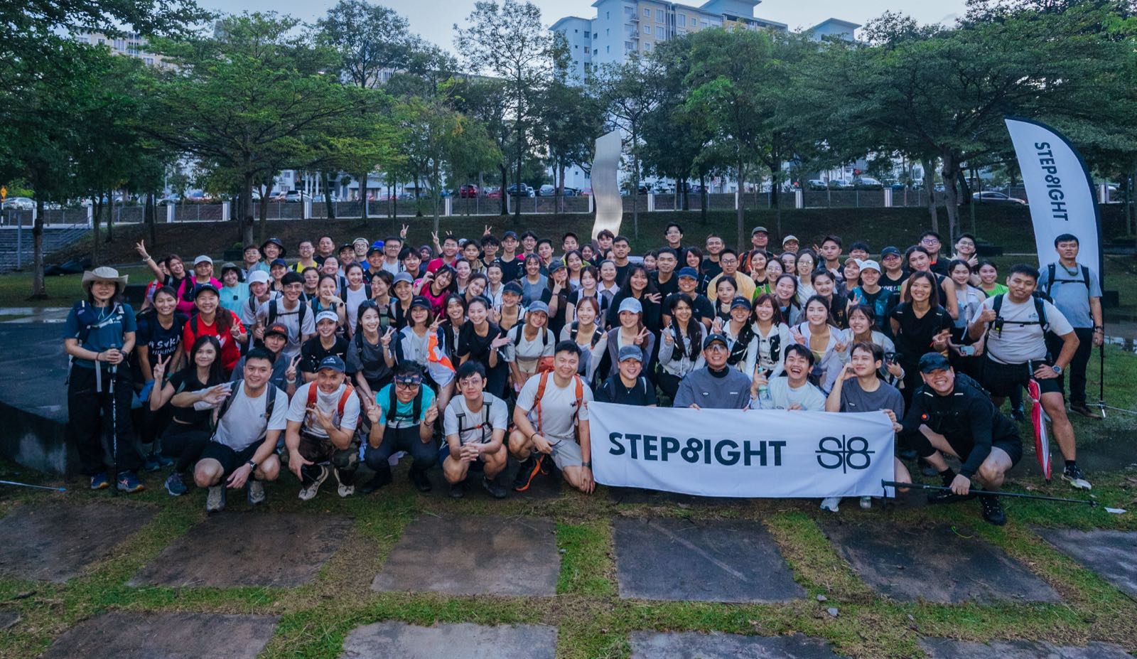 Large So Hikers group with the STEP8IGHT banner at the trailhead